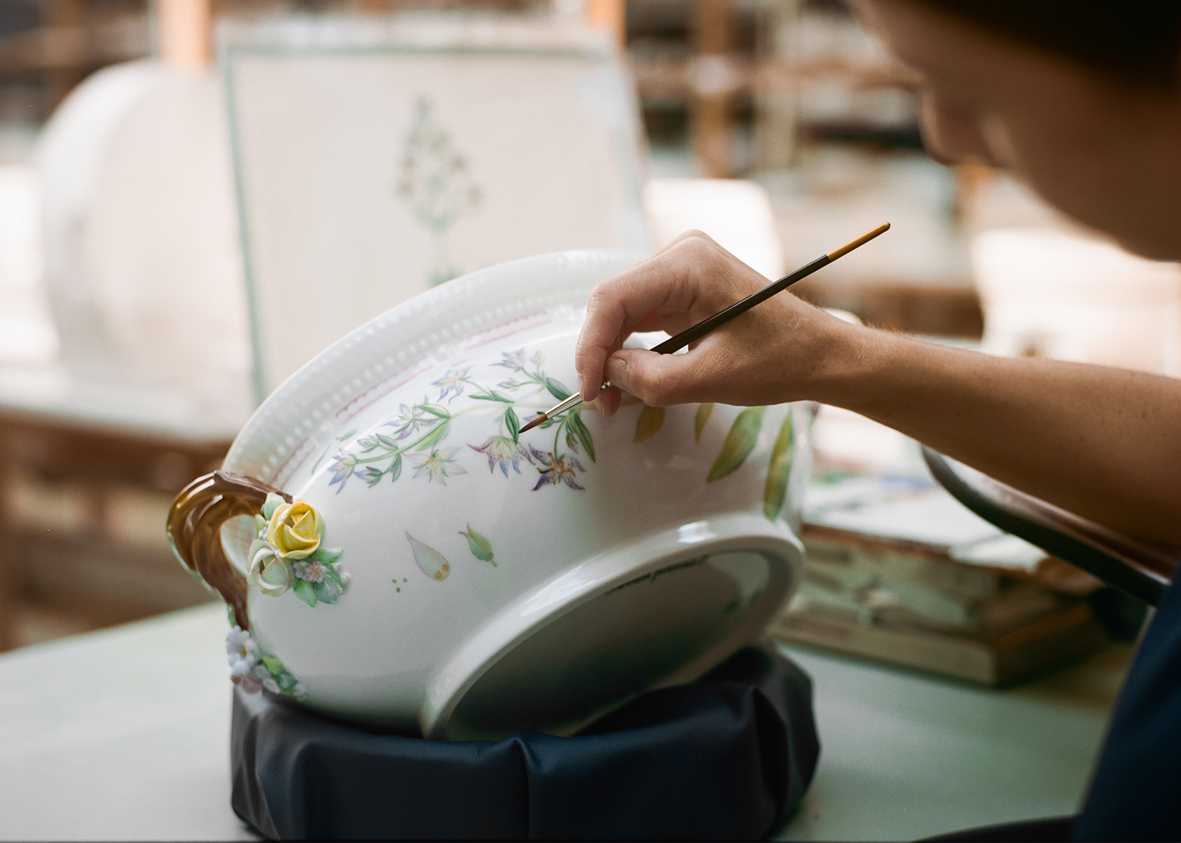 A painter painting Flora Danica